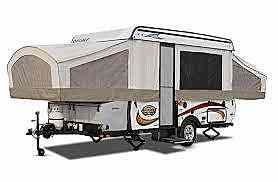 A small camper trailer with a large tent on the back. A small camper trailer with a large tent on the back.