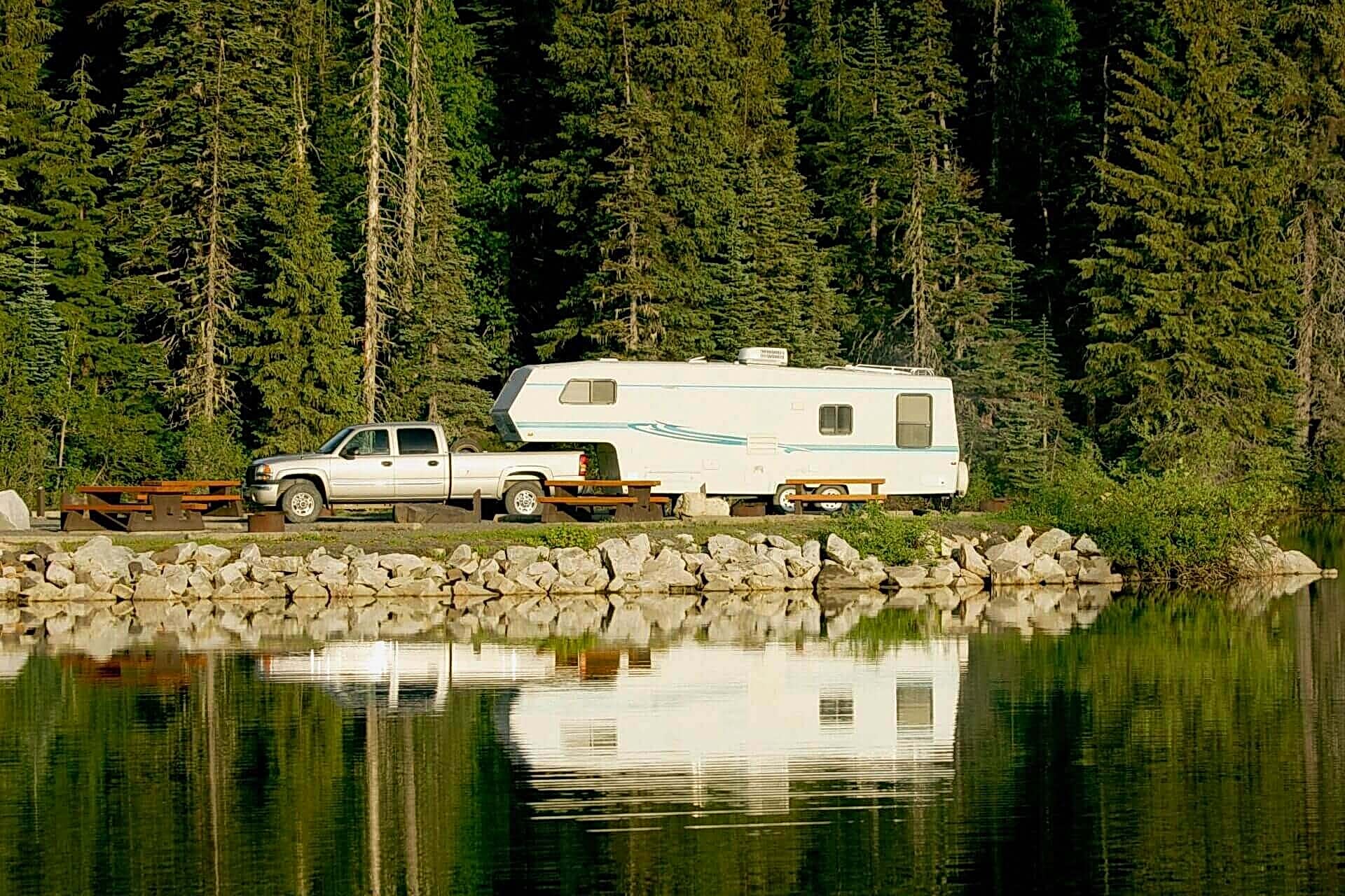 A truck parked next to a white trailer. A truck parked next to a white trailer.